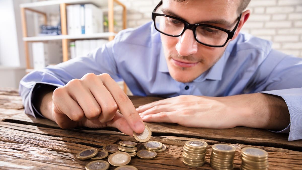 Businessman Counting Coins 