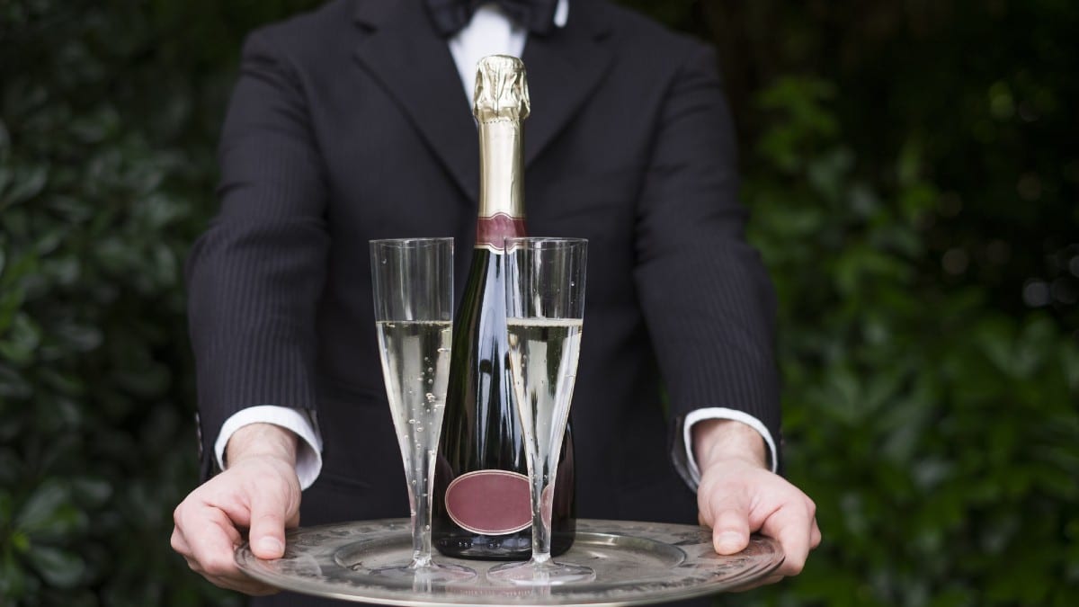 Remove BG Save Share Sample Professional waiter in uniform is serving champagne