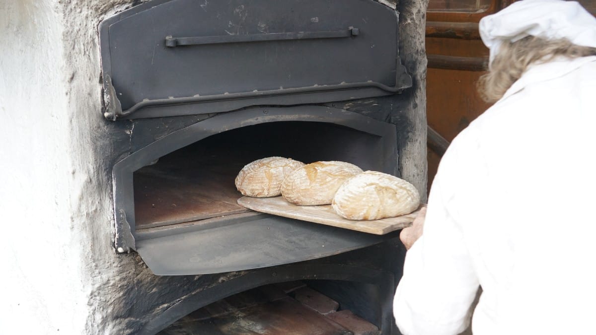 Traditonal bread baker in wood oven