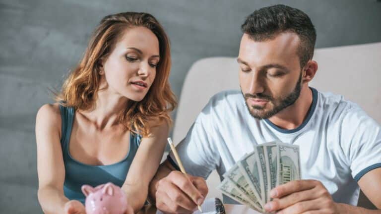 couple holding money and writing