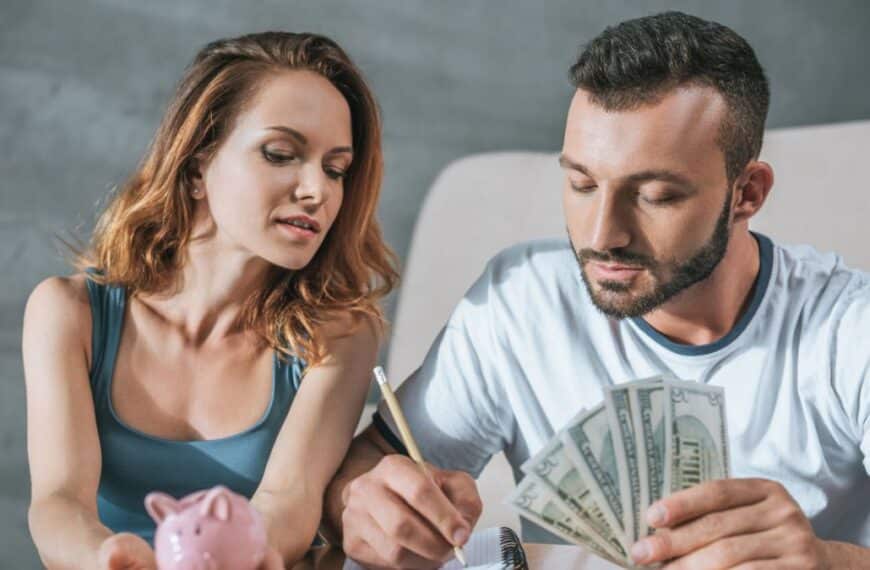 couple holding money and writing