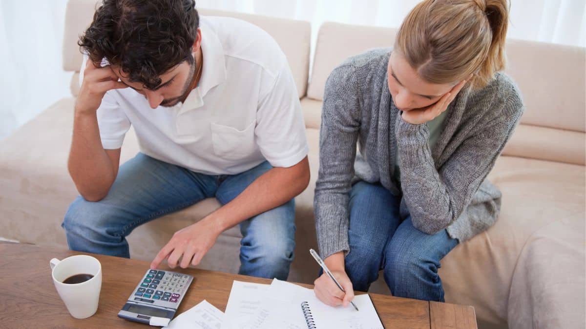 couple with calculator bills budget debt