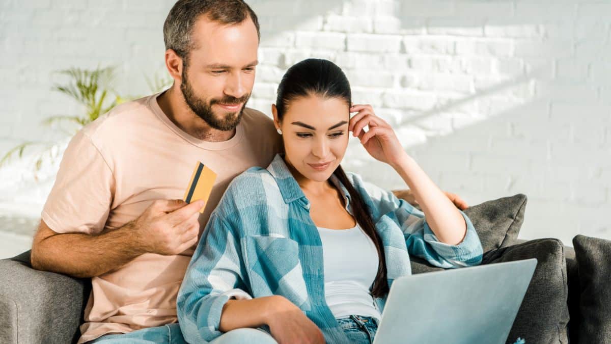 couple with credit card on a laptop