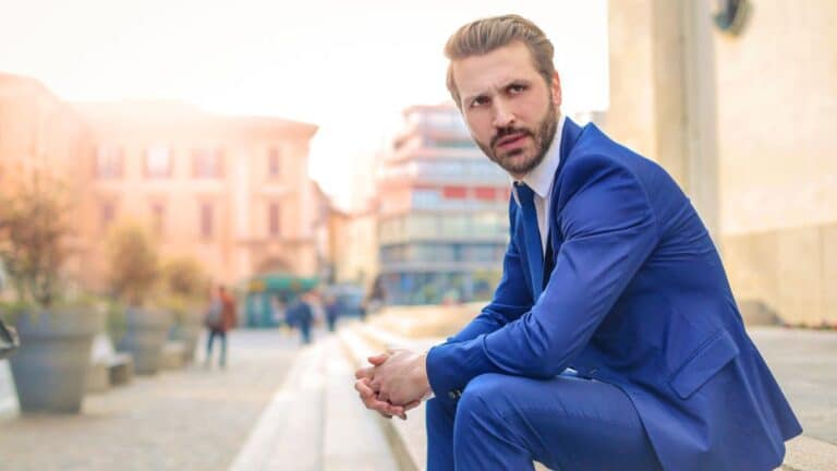 man in suit sitting on the side