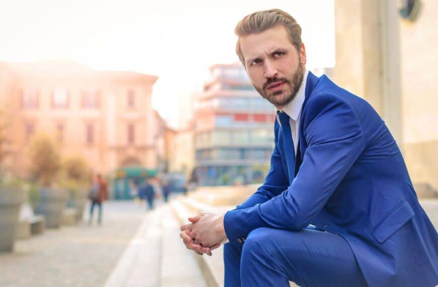 man in suit sitting on the side