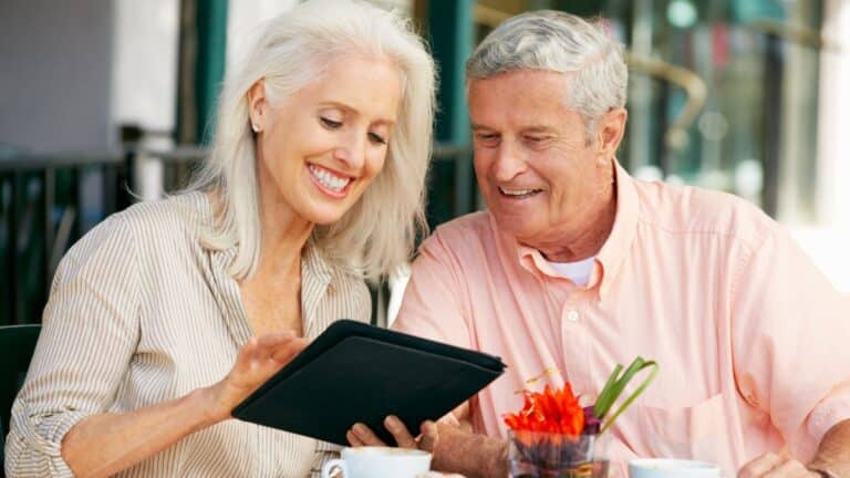 senior couple looking at tablet