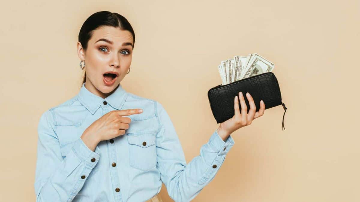 woman holding a purse with cash