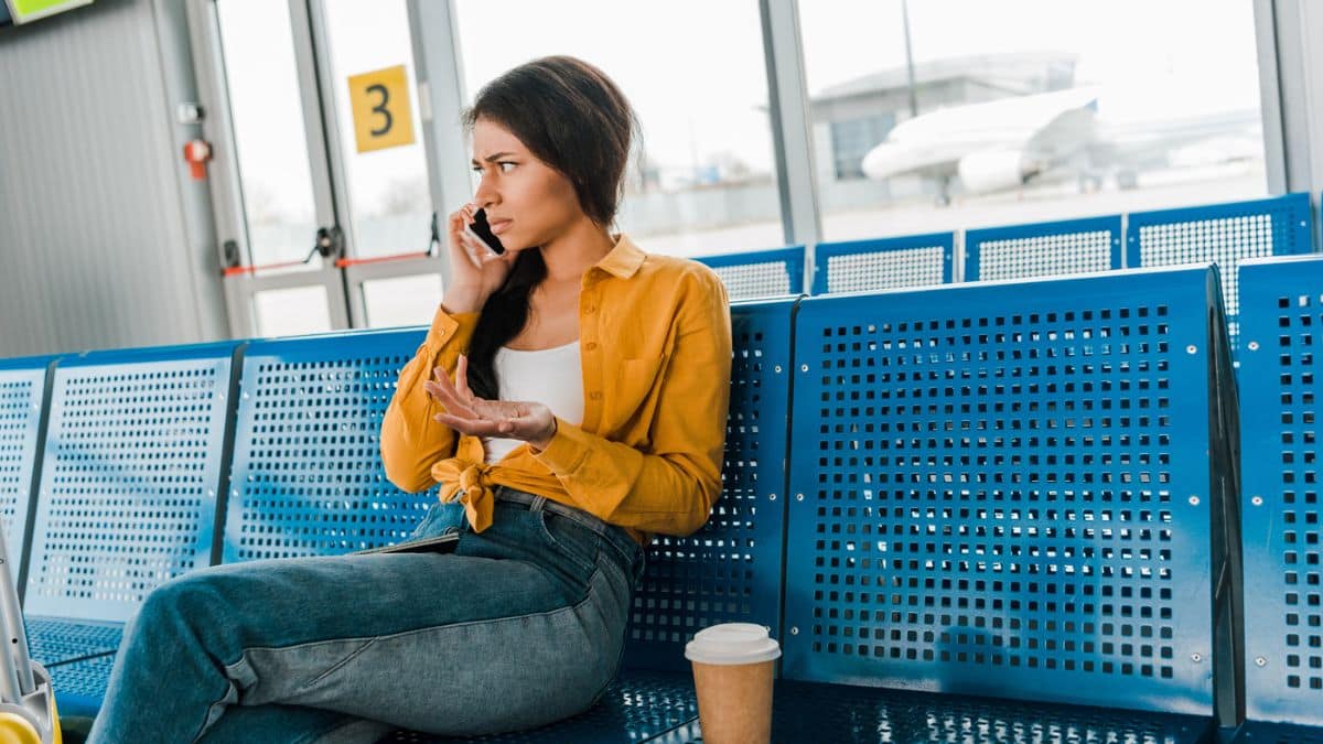 woman on phone upset at airport