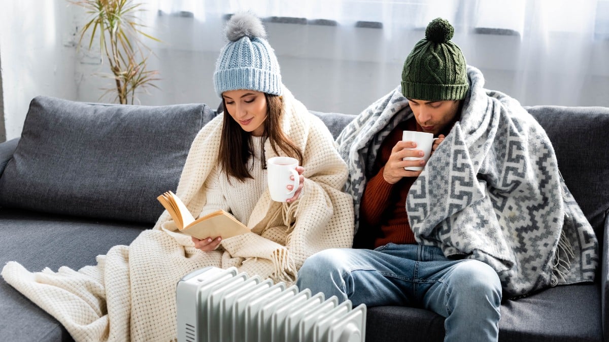 Attractive girlfriend reading book and boyfriend in winter outfit