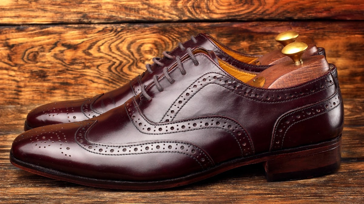 Brown man's shoes brogues on wooden background