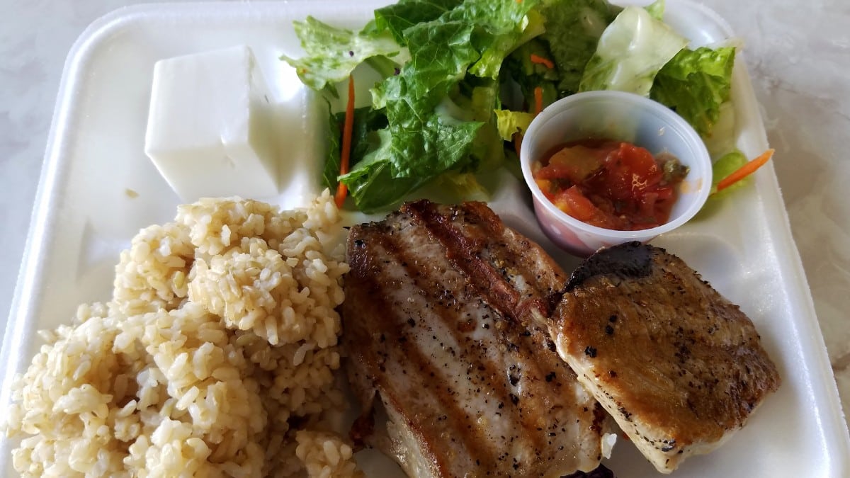 Grilled Ahi on styrofoam plate with tossed salad, Haupia and, two scoop
