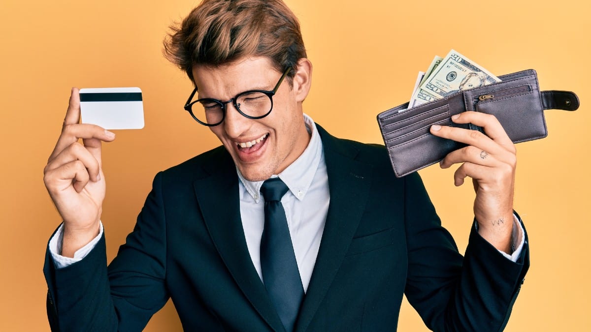 Handsome caucasian business man holding credit card and wallet