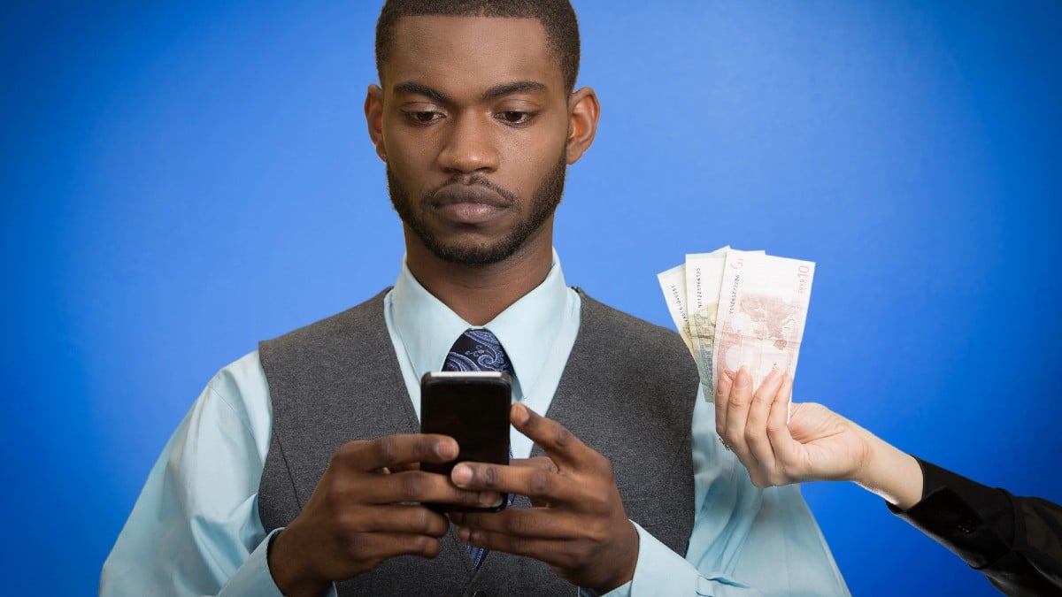 Man texting on smartphone, getting paid money