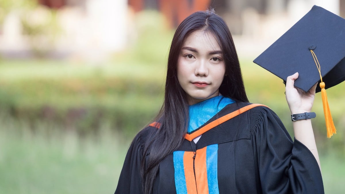 Portrait of happy and excited young Asian female university