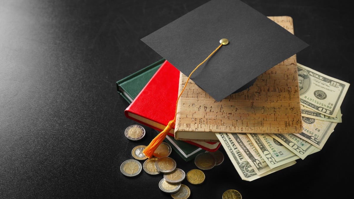 School supplies with graduation hat and banknotes