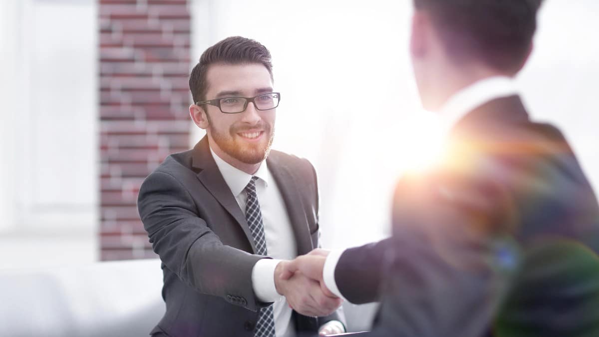 Two colleagues shaking hands after a business meeting