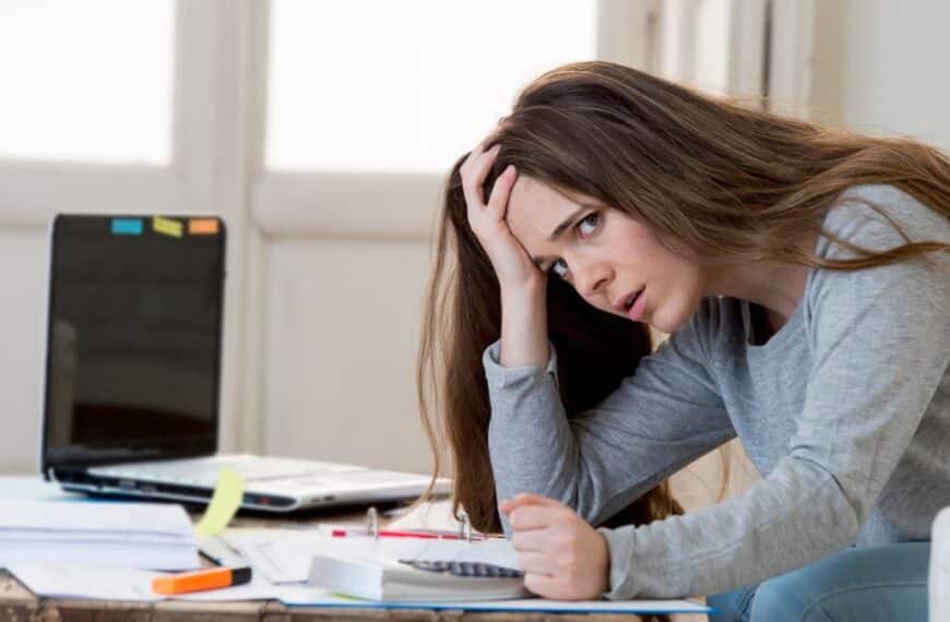 brunette woman worried doing accounting bills expenses
