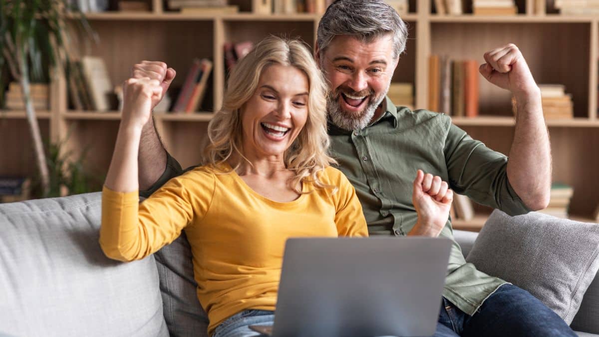 couple celebrating on a laptop