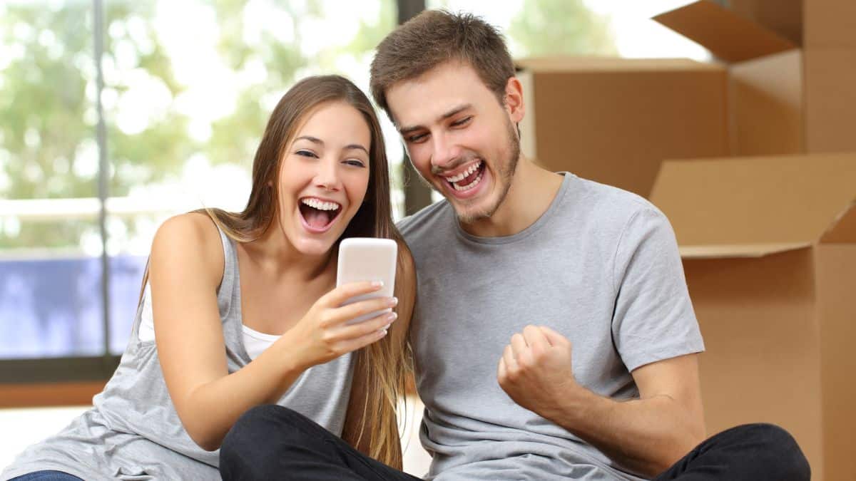 couple celebrating with their phone