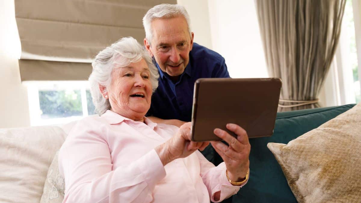 elder couple looking on a tablet