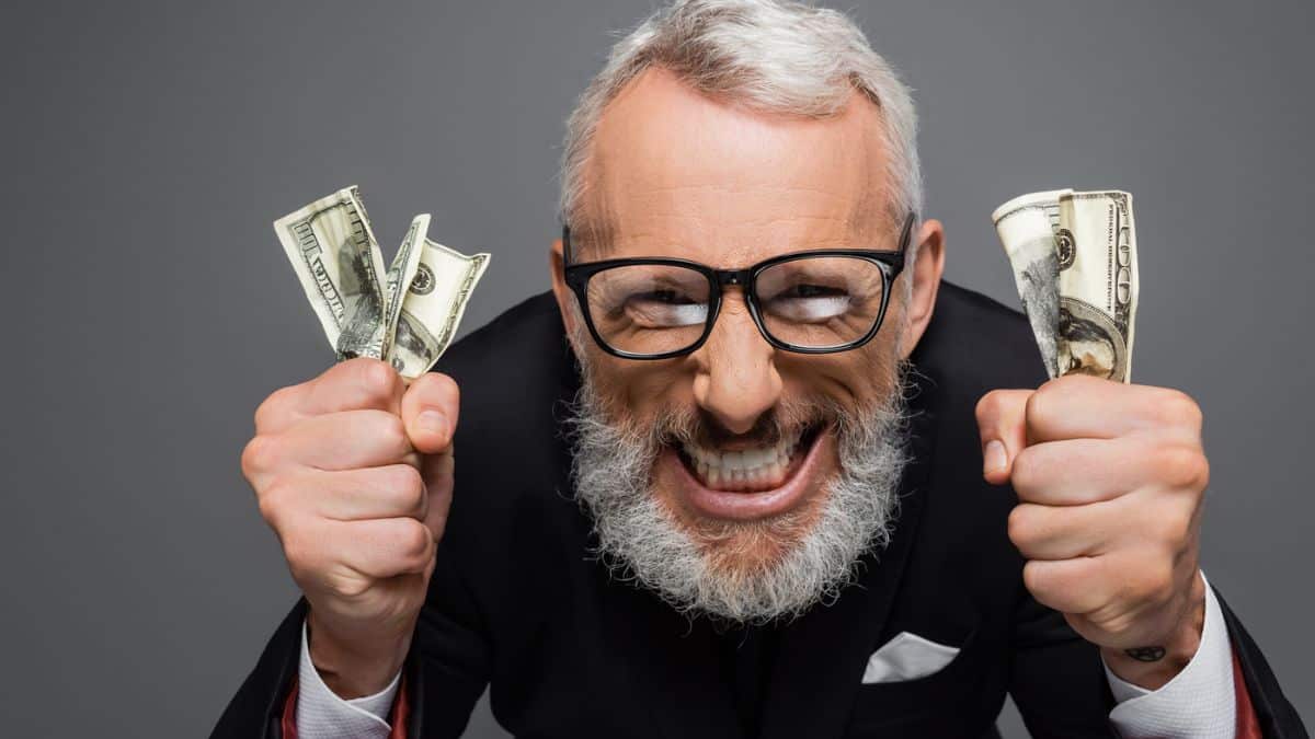 Man with beard glasses cash