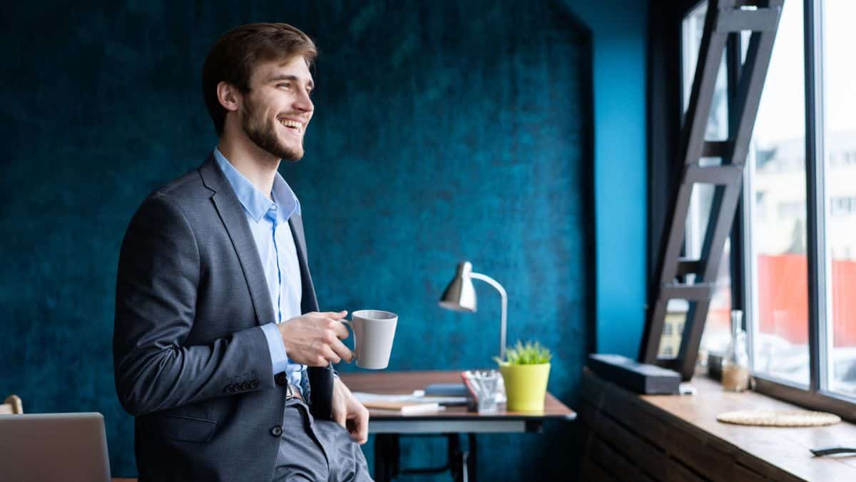 man with coffee in office