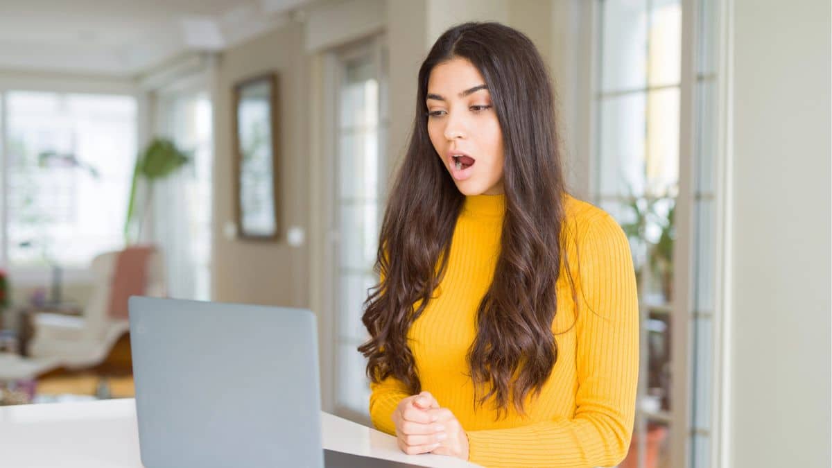 woman on laptop mouth open shocked