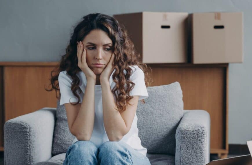 woman sad sitting with boxes