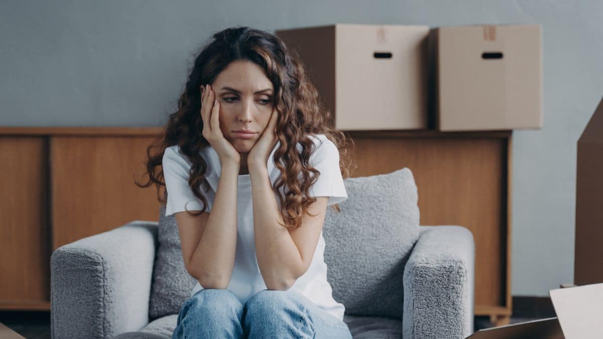 woman sad sitting with boxes