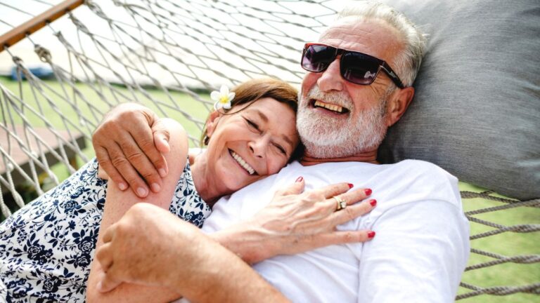 elder couple sitting on hammock