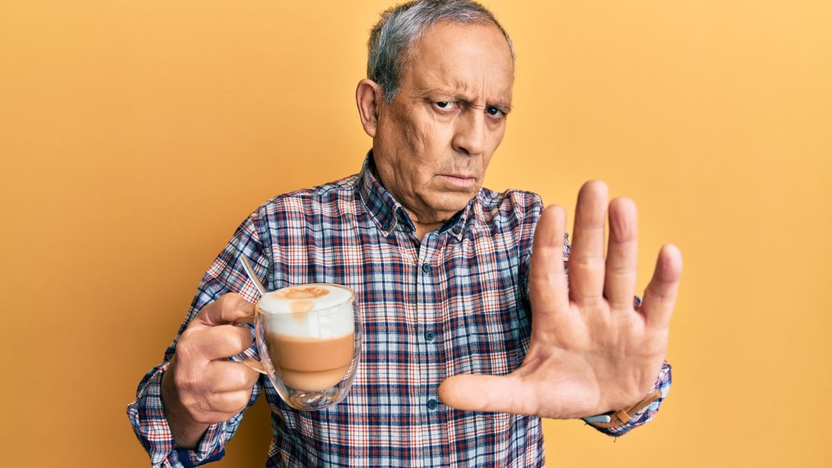 man with coffee stopping