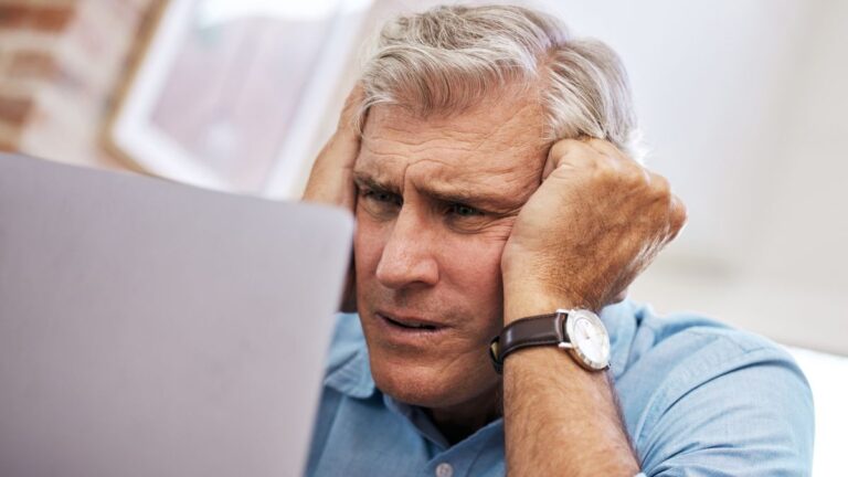 mature man leaning on hands worried