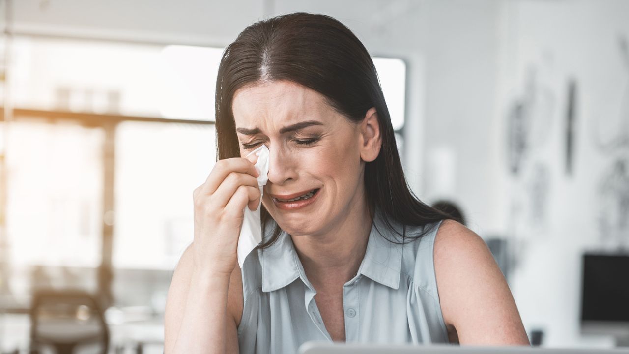 woman crying in front of a computer