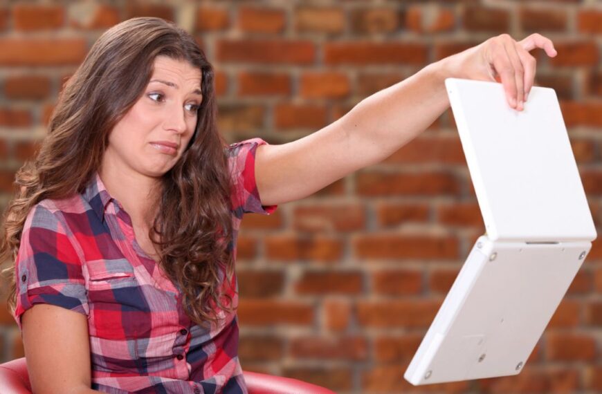 woman holding an old laptop