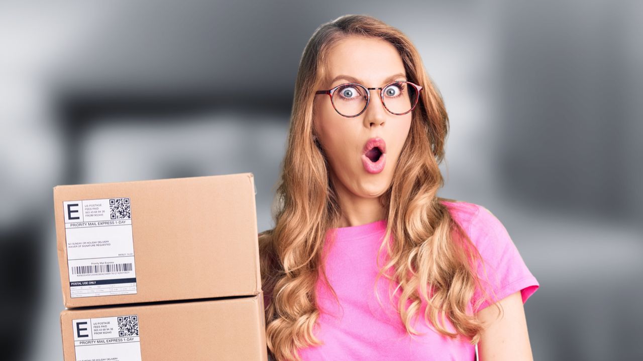woman with boxes shocked