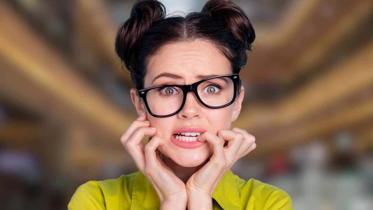 woman with glasses worried