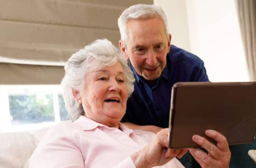 elder couple looking at a tablet