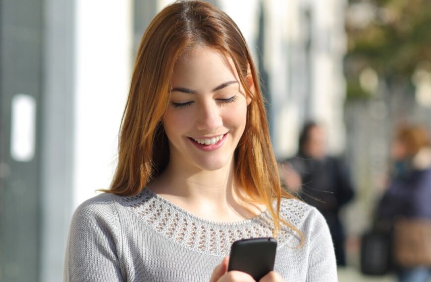 woman holding phone with smile