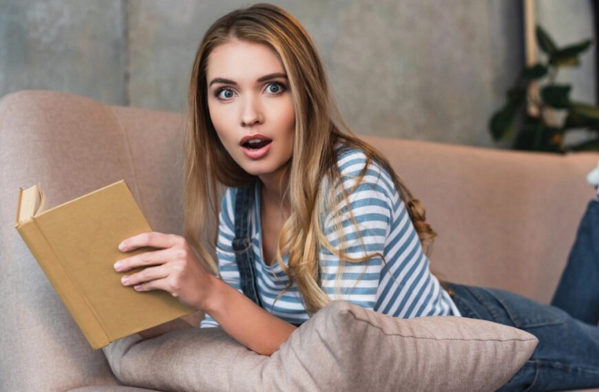 woman with book in shock
